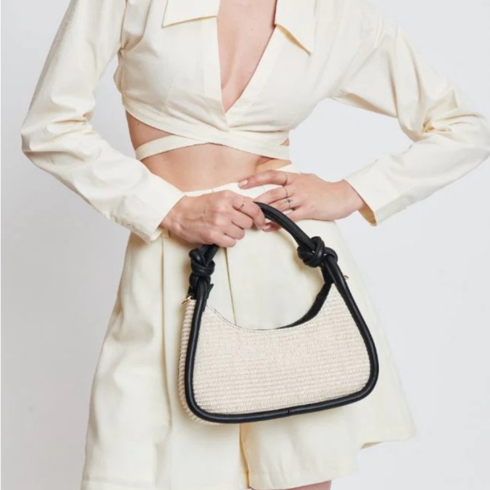 Moda Luxe Raffia Nicolette Crossbody bag with black trim.